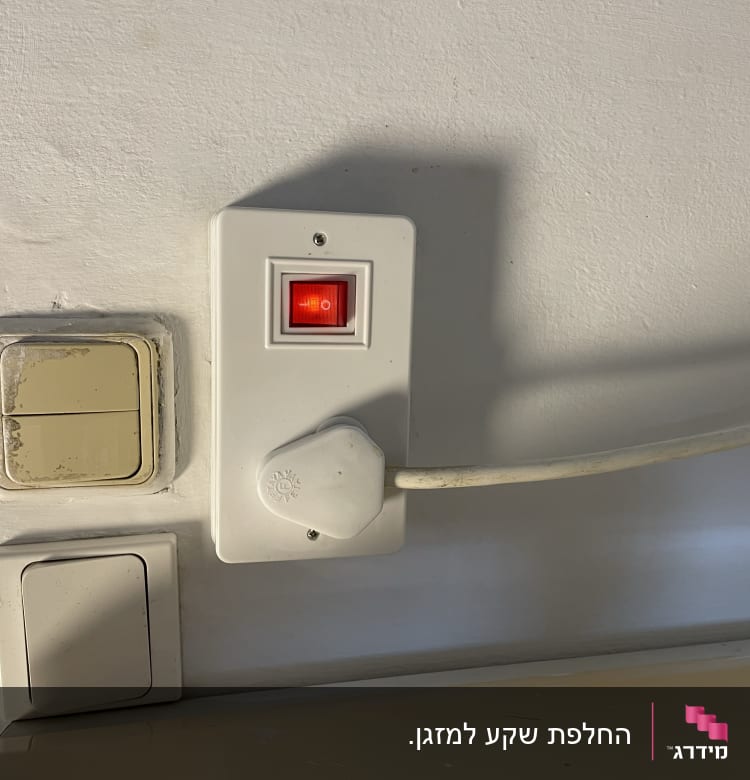 שקע חשמל עם מתג אדום וכבל מחובר